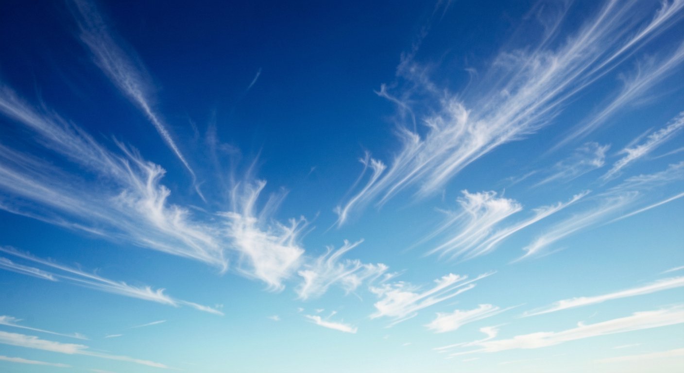 Bright blue sky with wispy cirrus clouds demonstrating Rayleigh scattering