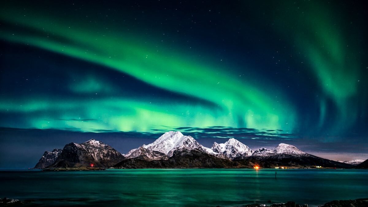 Northern lights aurora borealis over a frozen Arctic landscape during aurora season