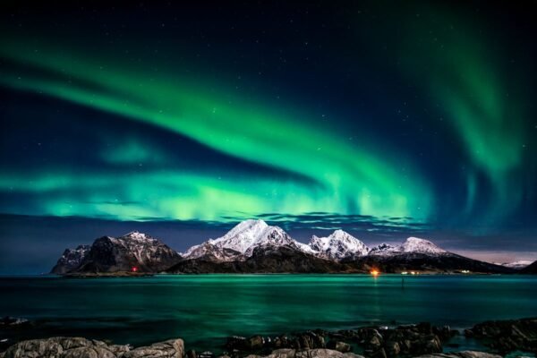 Northern lights aurora borealis over a frozen Arctic landscape during aurora season