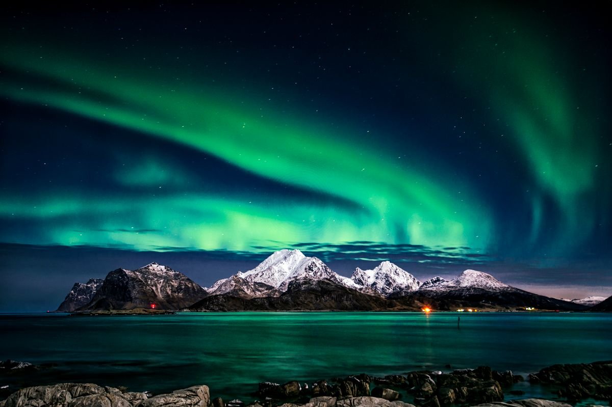 Northern lights aurora borealis over a frozen Arctic landscape during aurora season