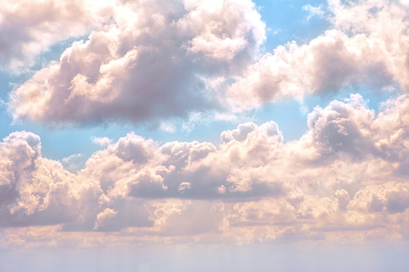 Different cloud types forming across a blue sky