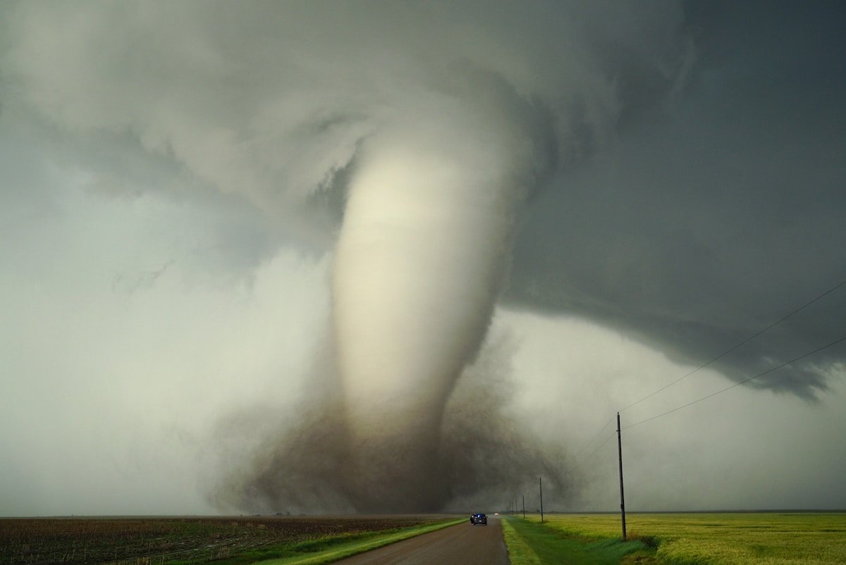 A tornado touching down on a rural road during a severe storm outbreak.