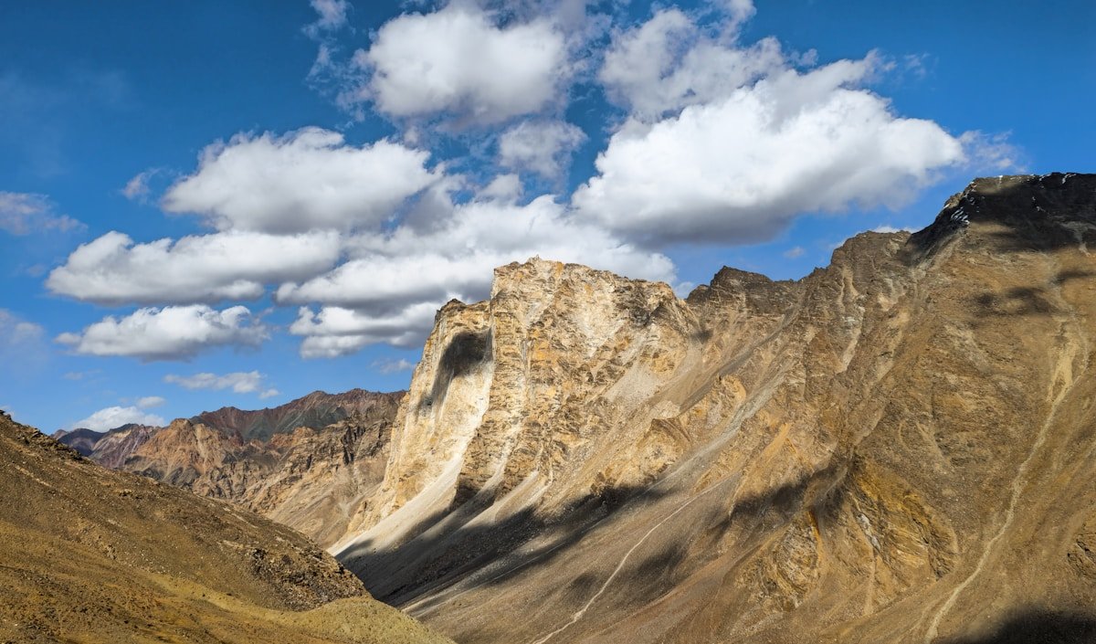 Rugged mountain landscape under blue sky in rewilded Scotland