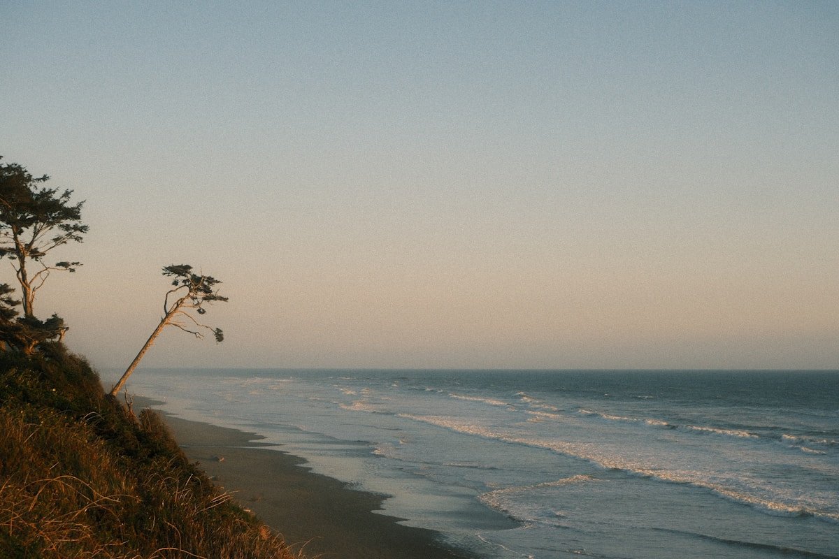 Coastal cliff overlooking a vast ocean with waves, El Nino weather
