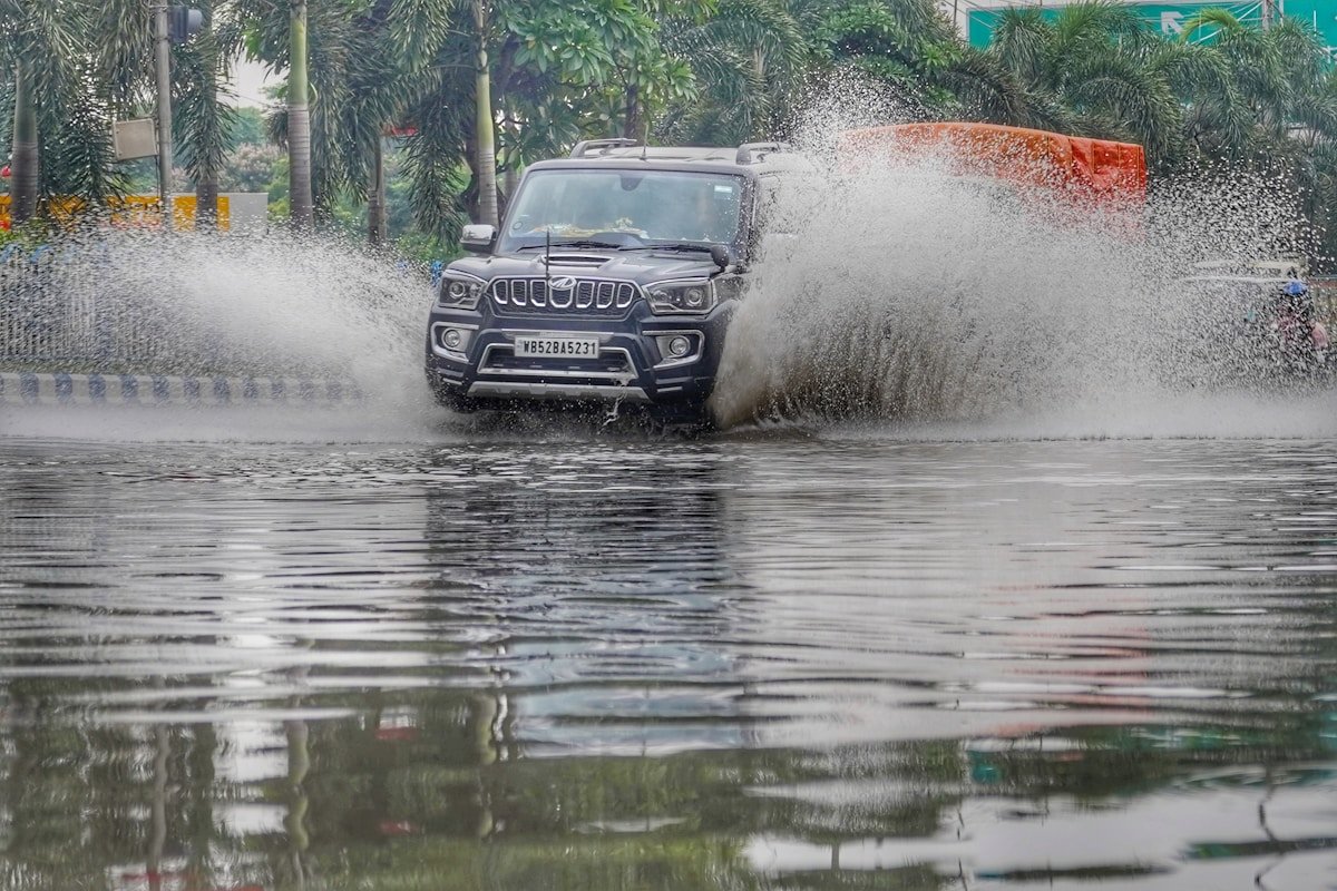 A car driving through flooded streets during monsoon season in India