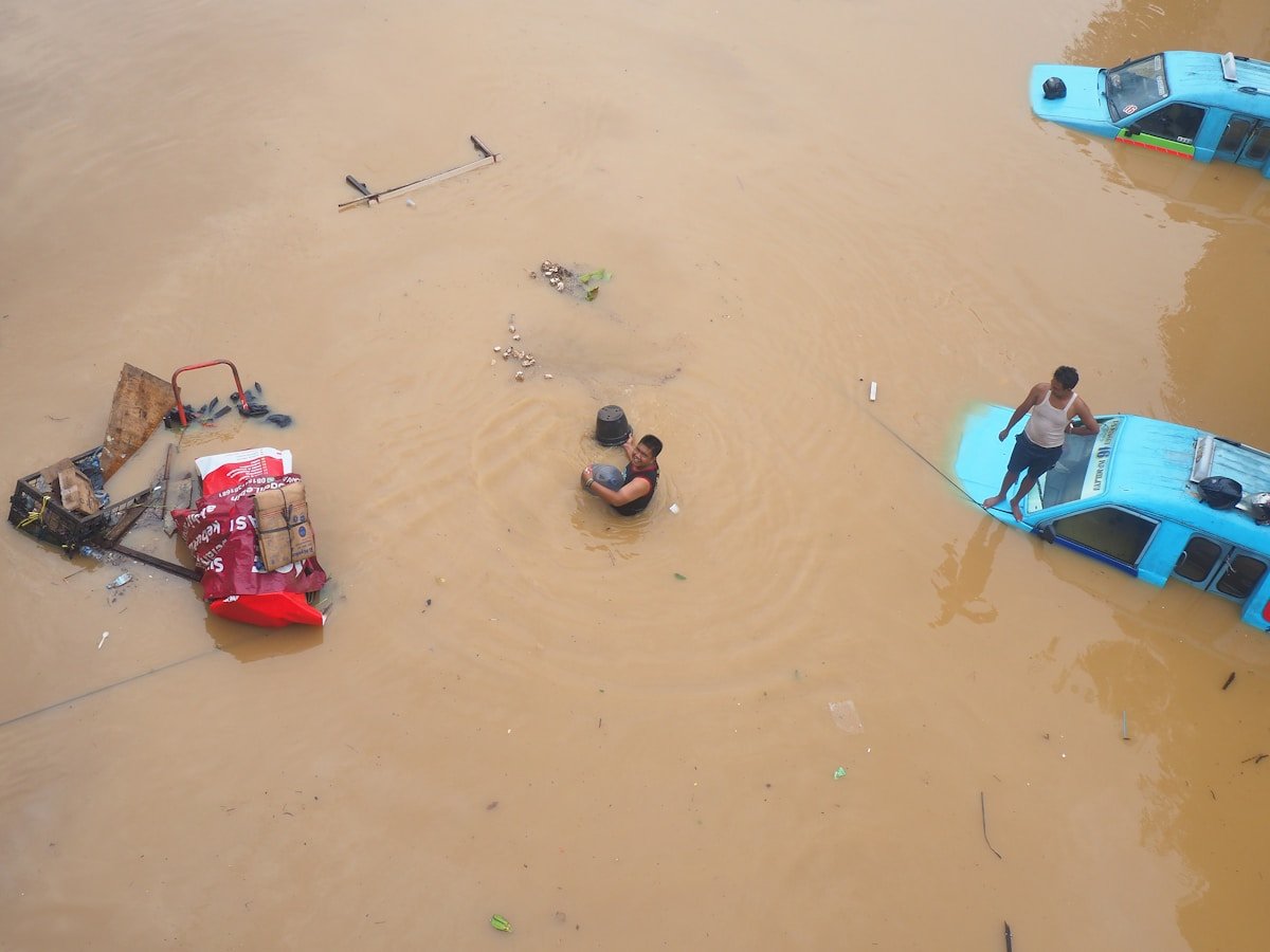 Flood waters trapping vehicles and rising around buildings