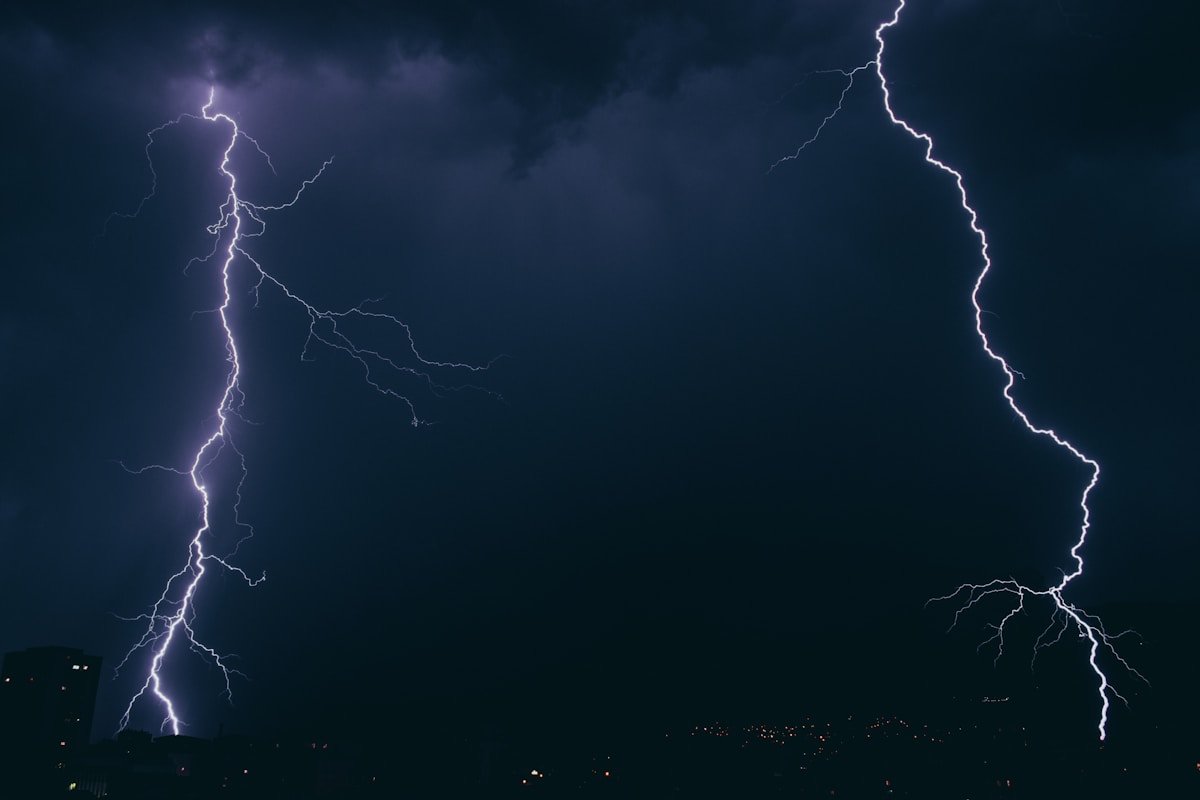 Lightning bolt striking from dark storm clouds
