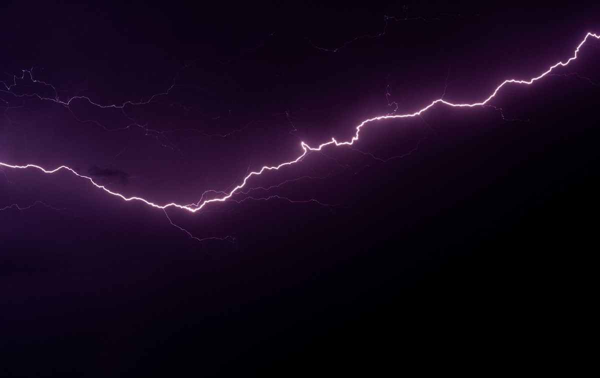 Lightning strike illuminating a dark night sky