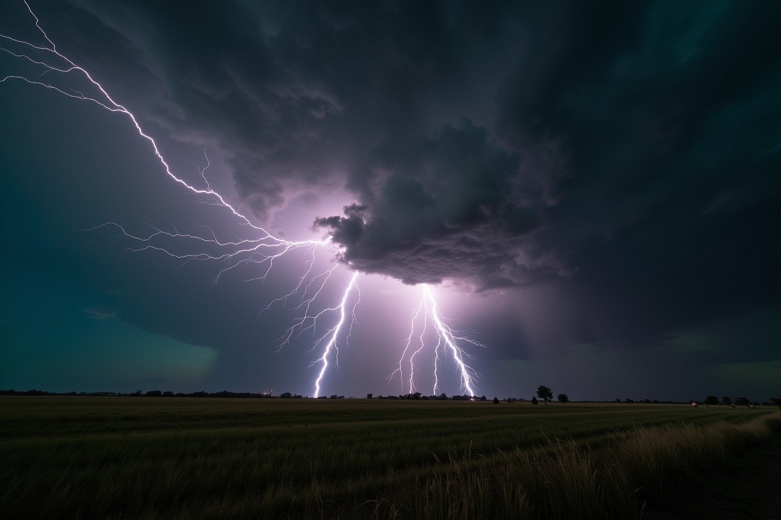 Dramatic lightning bolt striking the ground beneath a dark rotating supercell thunderstorm with wall cloud and rain shaft visible