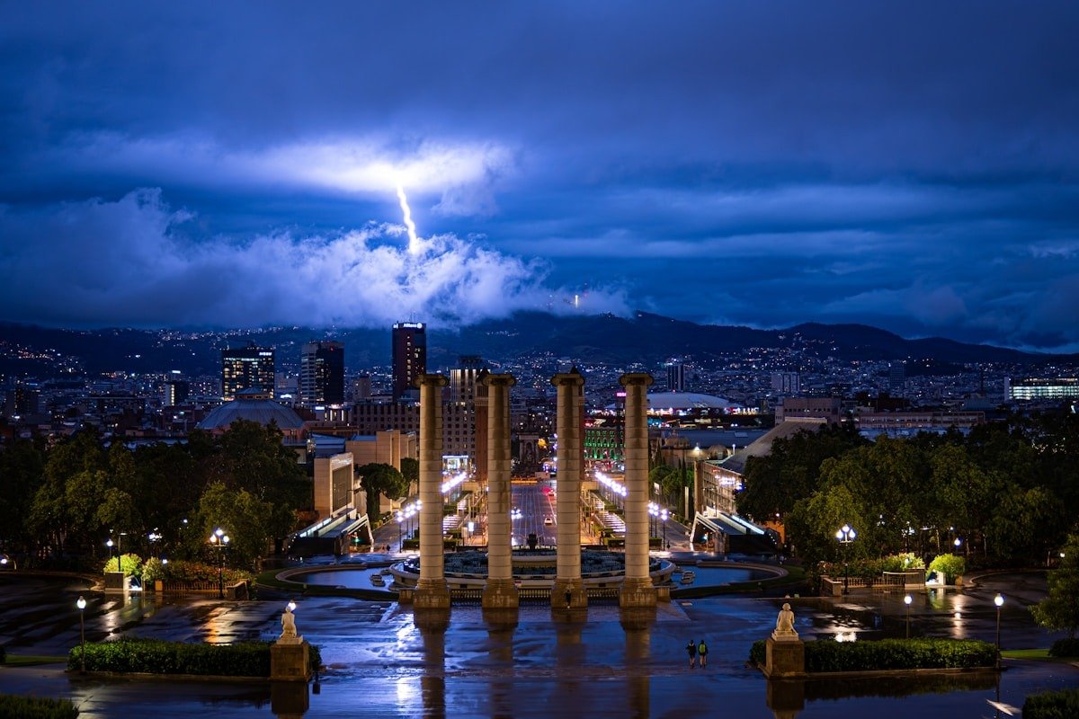 Lightning strikes over a city skyline at night