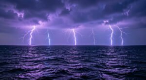 Multiple lightning bolts over a stormy ocean at night