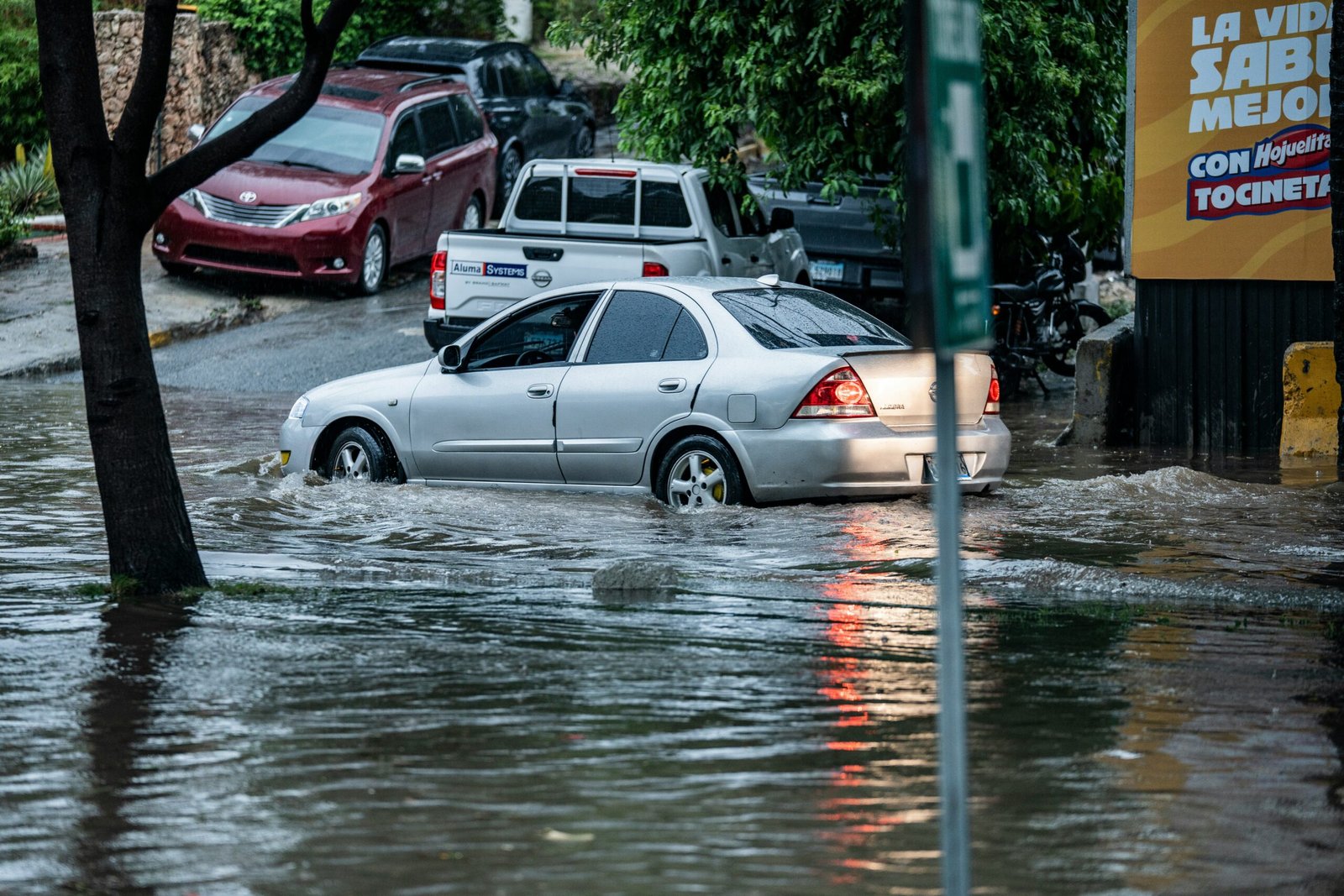 Cars driving through a flooded street after heavy monsoon rainfall