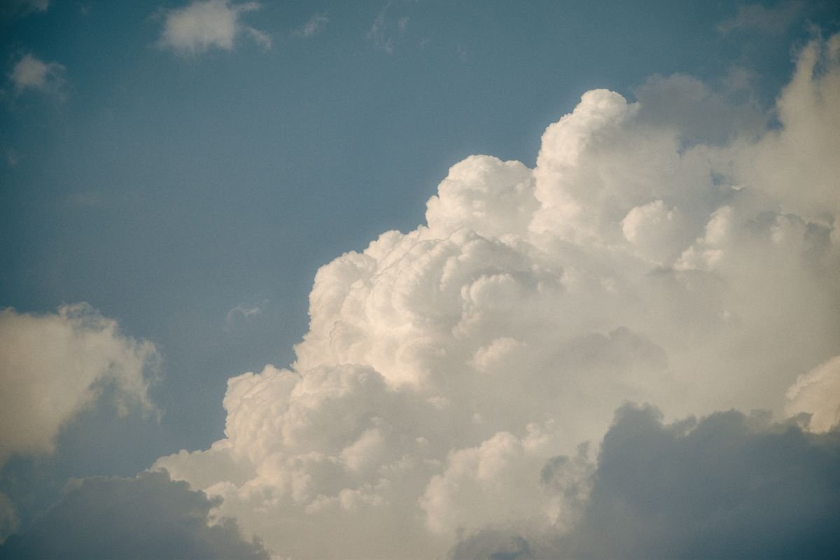 Dramatic cumulus clouds against a deep blue sky