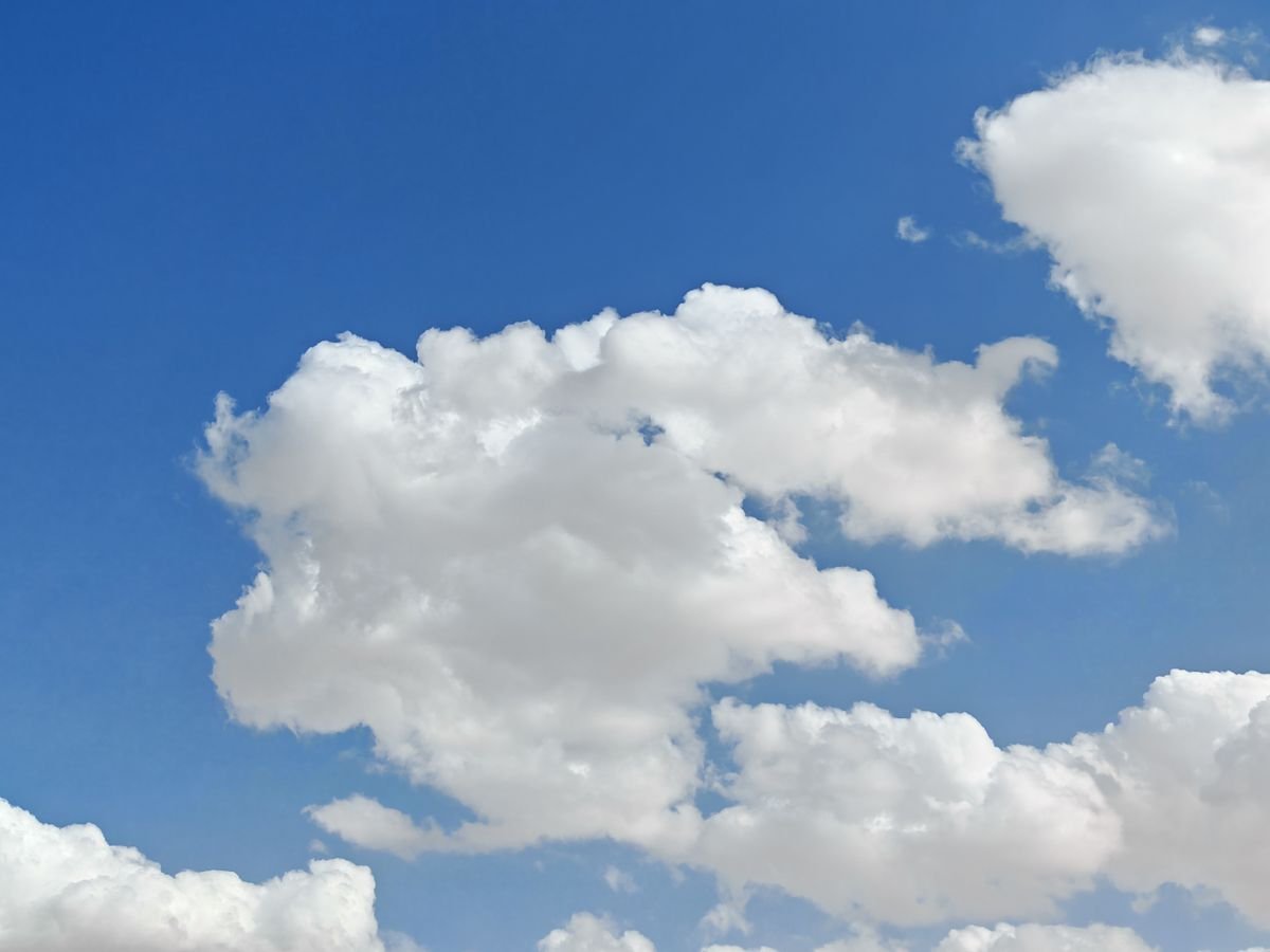 Fluffy cumulus clouds in a clear blue sky